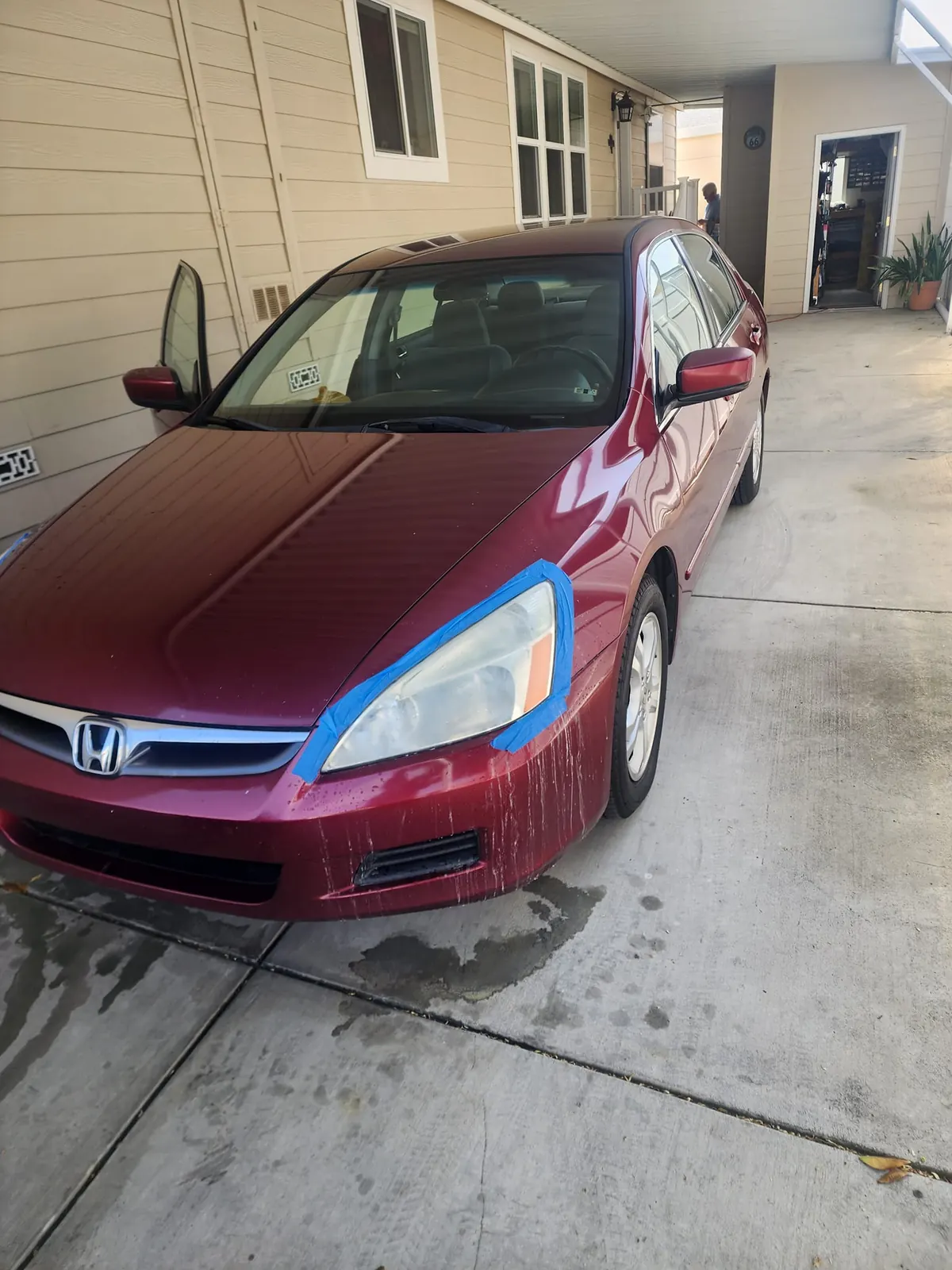 Honda Accord before detail with taped cloudy headlight