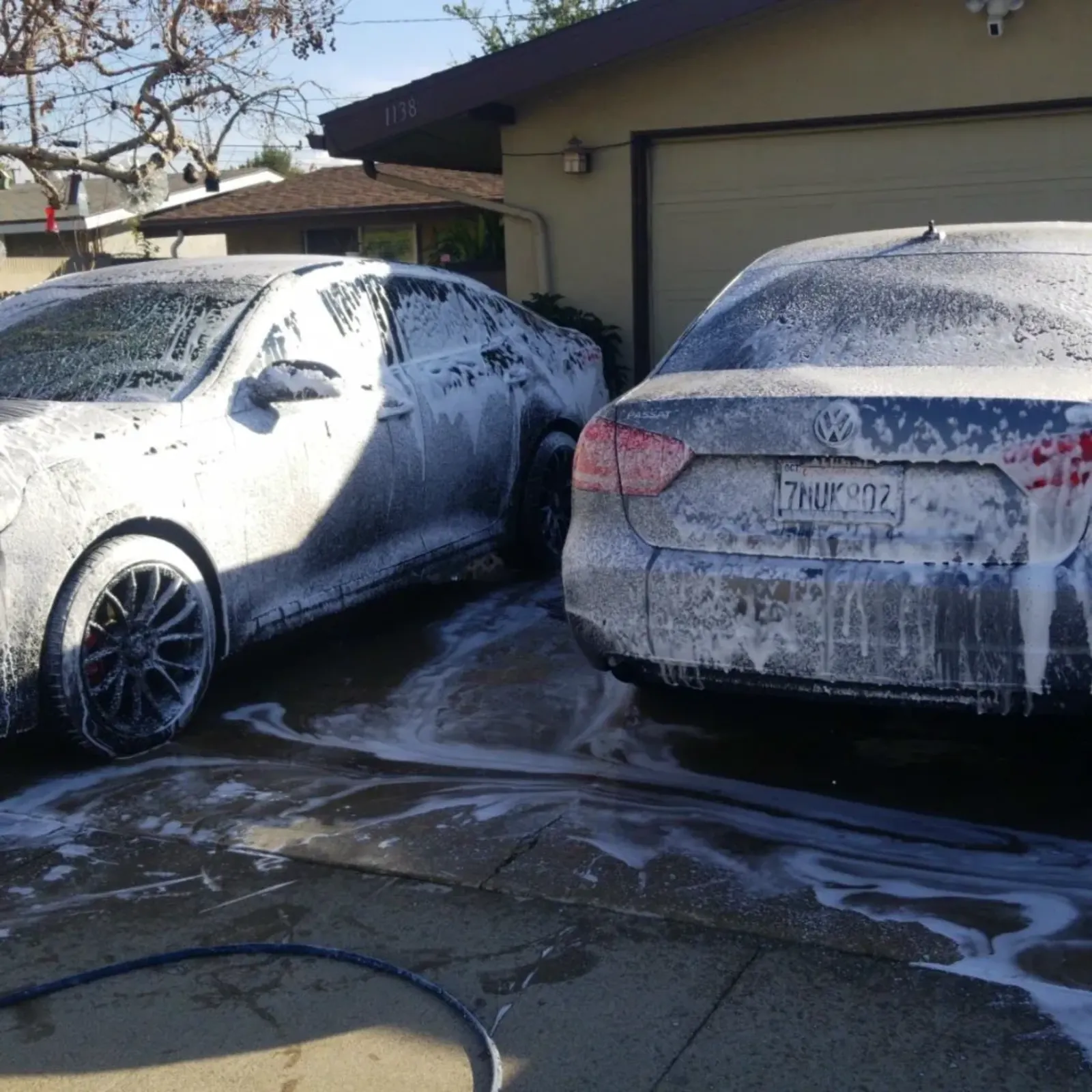 Two cars covered in foam before the final detail finish