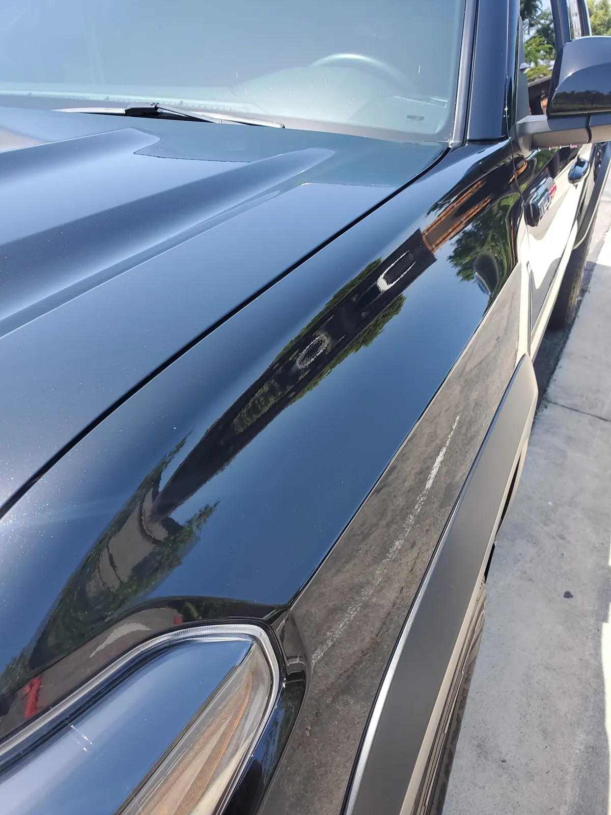 Truck fender with visible scratch before correction
